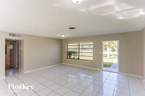 Plantation house for rent - an empty living room with a door to a yard