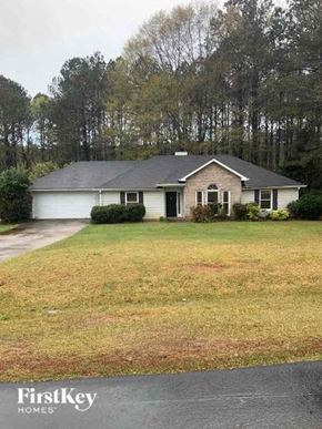 Covington house for rent - A house with a grey roof and a white garage door.