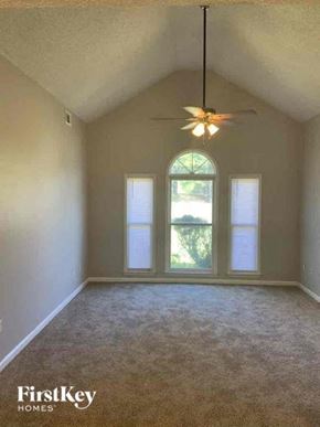 Covington house for rent - A room with a carpeted floor and a ceiling fan.