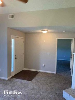 Covington house for rent - A room with a carpeted floor and two doors.