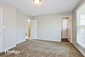 O'fallon house for rent - A spacious room with a carpeted floor and white walls.
