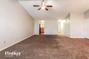 Brownsburg house for rent - A spacious room with a ceiling fan and carpeted floor.