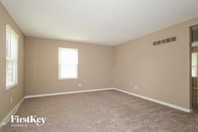 Florissant house for rent - a large empty room with carpet and a window