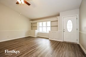 Kennesaw house for rent - A room with wooden floors and a white door.