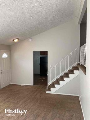 Addison house for rent - A room with a staircase and a door.