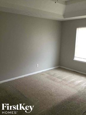Covington house for rent - an empty room with gray walls and a window