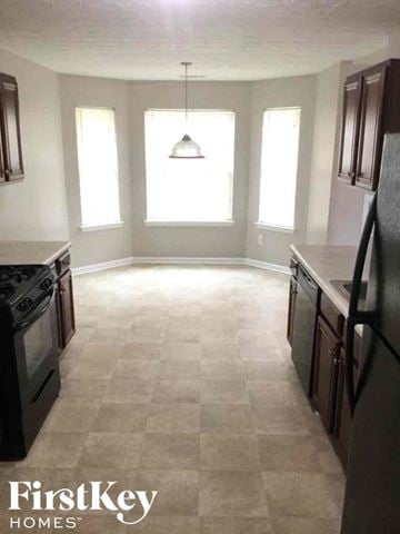 Covington house for rent - an empty kitchen in a house with a light hanging from the ceiling