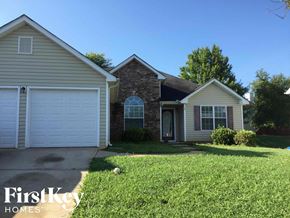 Covington house for rent - a home with a lawn and a white garage door