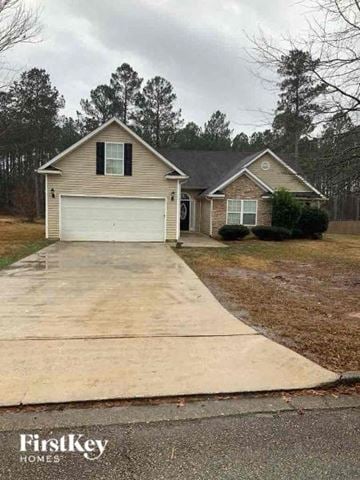 Covington house for rent - a house with a driveway and a white garage door