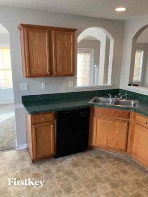 Covington house for rent - a kitchen with a sink and a black dishwasher
