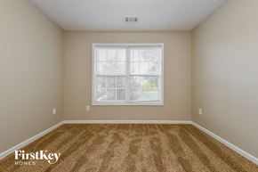 Covington house for rent - a spacious room with carpet and a large window