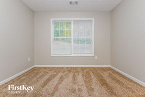 Covington house for rent - a bedroom with a large window and carpet