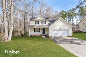 Fuquay Varina house for rent - a white house with a white garage door and a lawn