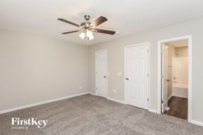 Fuquay Varina house for rent - a bedroom with a ceiling fan and a door to a closet