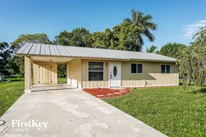 North Fort Myers house for rent - A house with a porch and a covered entrance.