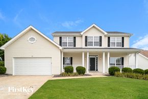 O'fallon house for rent - A two-story house with a garage and a balcony on the second floor.