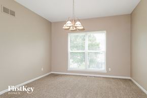 O'fallon house for rent - A room with a carpeted floor and a window with blinds.
