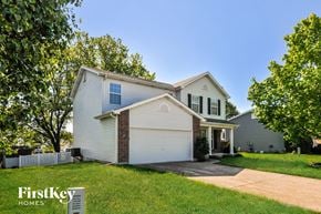 O'fallon house for rent - a white house with a driveway and a tree