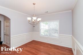 Dallas house for rent - a dining room with a window and a chandelier