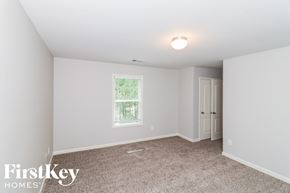 Dallas house for rent - a bedroom with white walls and carpet and a window