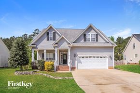 Garner house for rent - a suburban house with a driveway and a white garage door