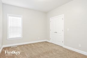 Garner house for rent - a bedroom with a door and a carpeted floor
