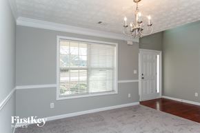 Covington house for rent - a renovated dining room with a large window and a chandelier