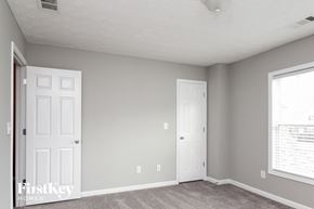 Covington house for rent - a bedroom with two white doors and a carpeted floor