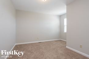 Greenwood house for rent - a bedroom with white walls and carpet and a window