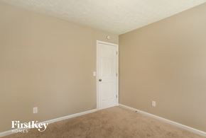 Rockmart house for rent - a bedroom with beige carpet and a white door