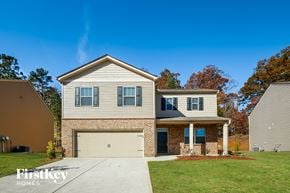 Dallas house for rent - a beige and brick house with a white garage door