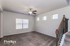 Cartersville house for rent - A spacious room with a staircase leading to the second floor.