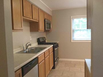 Streamwood house for rent - a kitchen with a sink and a stove and a window