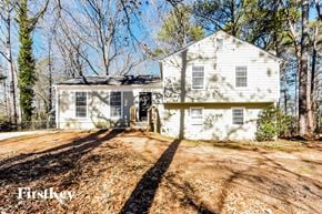 Stockbridge house for rent - a white house with a dirt road in front of it
