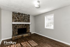 Stockbridge house for rent - the living room has a stone fireplace and wood flooring
