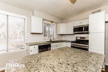 Stockbridge house for rent - an updated kitchen with granite counter tops and white cabinets