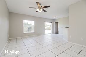 Sebastian house for rent - a clean and empty living room with a ceiling fan