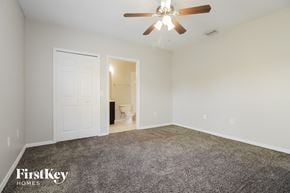 Sebastian house for rent - the spacious living room with carpeted flooring and a ceiling fan