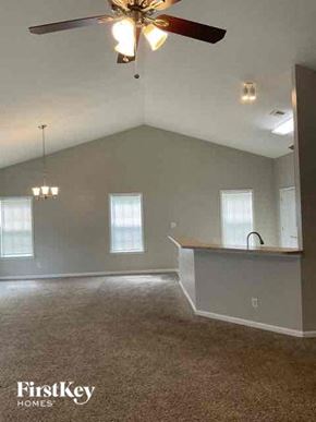 Mooresville house for rent - A room with a ceiling fan and a window.
