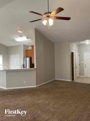 Mooresville house for rent - A room with a ceiling fan and a carpeted floor.