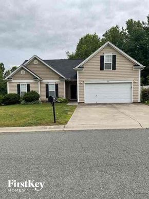 Mooresville house for rent - A house with a garage and a sign that says FirstKey Homes.