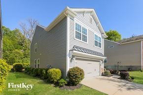 Charlotte house for rent - a with a white garage door and a lawn