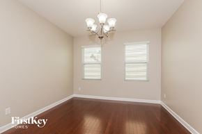 Charlotte house for rent - a empty dining room with wood floors and a chandelier