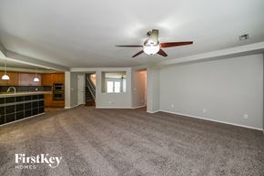Summerville house for rent - A spacious room with a ceiling fan and a carpeted floor.