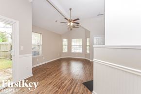 Summerville house for rent - A room with wooden floors and a ceiling fan.