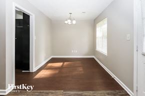 Hampton house for rent - a dining room with hardwood flooring and white walls and a window