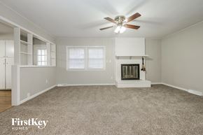 Belton house for rent - A spacious living room with a fireplace and a ceiling fan.