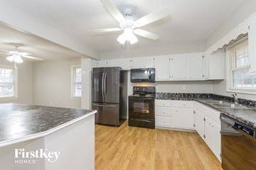 Belton house for rent - A kitchen with a refrigerator, oven, and microwave.