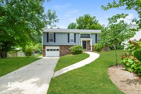 Trussville house for rent - a blue house with a sidewalk in front of it