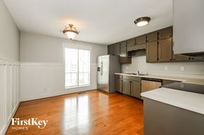 Trussville house for rent - a kitchen with stainless steel appliances and a wood floor